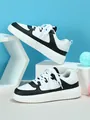 Detailed side view of black and white platform sneakers featuring a soft-sole lace-up design - 38 / Black and White