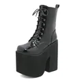 Detailed view of women's black patent leather platform boots with super high block heels - 35 / Black