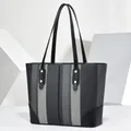 Front view of a striped tote bag with elegant black leather straps and gold rivets - 35x12x25cm / Black