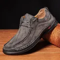 Detailed macro shot of textured grey leather men's driving loafer with handmade stitching - 38 / Gray