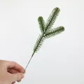 Macro detail of a green artificial three-pronged pine branch for Christmas DIY decor - Small-Green