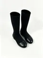 Detail view of black knee-high stretch boots with leather-like round toe and low heel. - 35 / Black (Round Toe)