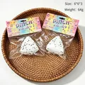 Realistic onigiri rice ball squishy toy in packaging with 64g weight and 6x6x3cm size - Triangle Rice Ball