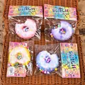 Macro view of four colorful gradient donut slow rebound squishy toys in retail packaging - Bitten Donut