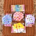 Detailed view of colorful waffle-shaped slow rebound squishies in Pinch Family boxes - Waffle / Random Color