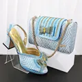 Close-up of light blue snakeskin texture party shoe and matching handbag set. - Sky Blue