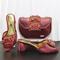 Detail of burgundy metallic cracked shoes and matching rhinestone evening bag set. - Burgundy