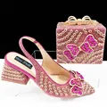 Close-up of magenta rhinestone heels and matching clutch with crystal butterflies. - 39 / Shoe And Bag Set (QSL098) / Rose Red