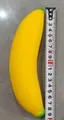 Soft TPR yellow banana squeeze toy for stress relief shown with measuring tape tool - Little Banana / Yellow