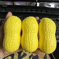 Three yellow peanut-shaped PU slow rebound squishy toys held in hand for stress relief - Peanut Squishy / 3 Pieces/Pack