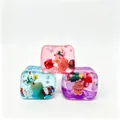 Macro view of three colorful Christmas squishy toys featuring Santa and gingerbread miniatures - OPP Bag / Green