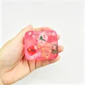 Detailed macro shot of a pink Christmas themed squishy toy stress reliever cube with gingerbread man - Box Packaging / Christmas Pink
