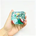 Detail view of square blue squishy toy featuring festive Santa and snowman figures - Box Packaging / Christmas Blue