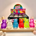 Colorful aurora gummy bear maltose squishy toys on a wooden tray for stress relief. - Glitter Maltose Bear (Pink)