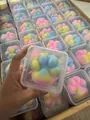 Close-up detail of a colorful cat paw squishy toy packaged in a clear plastic box - Colorful Cat Paw