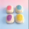 Detail view of four colorful slow rebound squishy PU bread toys with cute cow patterns - Milk Bread