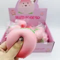 Close-up detail showing the soft slow rebound texture of the pink peach squishy toy. - Peach Style / 1 Piece
