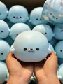 Soft light blue seal squishy toy being squeezed by hands for sensory stress relief - Color Box / Blue-Grey Spotted Seal