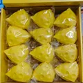 Pack of 12 yellow cheese stress relief toys individually wrapped in a yellow box. - 7cm Triangle Style