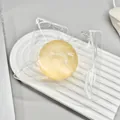 Yellow translucent maltose squishy ball stress relief squeeze toy shown in plastic bag - Yellow