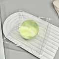 Soft green coconut oil squishy stress relief toy ball in a clear plastic pouch - Green