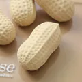 Close-up of peanut-shaped squishy toy showing realistic surface texture - Simulated Peanut / Beige