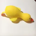 Detail view of the yellow duck stress relief toy showing its soft, squishy texture - Yellow Duck