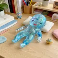Close-up of colorful glitter inside the translucent blue baby squishy toy - Natasha Doll / Blue Natasha Doll