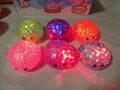 Detailed macro view of colorful LED light-up squishy bun toys with glitter filling - Light Up Glitter Burst Bead Bun Style / 8.5cm
