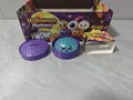 Halloween light-up blue glitter bun squeeze toy presented inside a purple steamer box - Light Up Halloween Glitter Bun (Style D)
