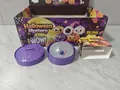 Detailed macro view of a Halloween eyeball squishy toy with purple steamer container - Halloween Glitter Burst Giant Bun (Style B)