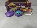 Halloween mystery box glitter squishy toy with purple steamer container detail view - Halloween Glitter Burst Giant Bun (Style D)