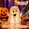 Nahaufnahme von orangefarbenem Glitzer-Geist-Quetschspielzeug mit Halloween-Deko - Geister-Stil / Orange