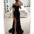 Elegant black sequined off-shoulder evening gown with high slit and shimmering finish. - Black
