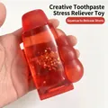Macro detail of red transparent toothpaste-shaped squeeze toy with glitter stars inside - Red Star Toothpaste