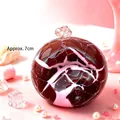 Close-up of strawberry flavored crispy handmade decompression squishy ball with marble pattern - Strawberry Crispy Ball