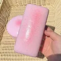 Detailed macro view of a pink speckled slow-rebound PU squishy toy inside a basket - Pink Long Rice Cake