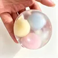 Transparent stress relief squeeze ball containing colorful soft inner spheres for anxiety relief - Rice Ball Squishy / Macaron Color