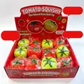 Detailed view of red and yellow tomato squishy toys in a display box for stress relief - Random Mixed Color (Display Boxed)