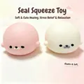 Detail view of pink and white seal squishy toys with soft slow rebound texture. - Color Box / Pink