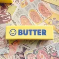 Langsam zurückfederndes gelbes Butter-Stab-Quetschtier mit Smiley und Butter-Aufdruck - 14cm Lächeln Butterstange / Gelb