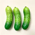 Close-up of three green pickle squishy stress relief toys on a plain white background. - Simulation Cucumber