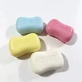 Nahaufnahme von vier bunten Seifen-Knautschspielzeugen in Blau, Rosa, Gelb und Weiß. - Seife - Rosa / Beutelverpackung