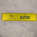 Yellow butter stick squishy slow rising fidget toy displayed on white fur background - Oversized / Pure Gold