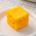 Realistic yellow cube cheese shaped PU squishy toy for stress relief on a white plate - Cheese Block (030) / 5x5cm / Yellow