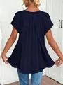 Detailed view of the elegant pleated back design on a navy blue short sleeve top - Navy Blue