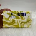 Close-up of yellow marble swirl butter stick slow rebound PU squishy toy for stress relief - Marble Butter Stick / Gold Marble (14cm)
