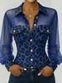 Detailed view of blue leopard print shirt with sheer mesh sleeves and gold buttons. - S / Tops / Blue