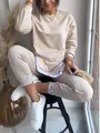 Detailed view of women's beige patchwork faux two-piece sweatshirt and matching joggers - S / Top And Bottom / Apricot