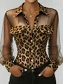 Close-up detail of elegant leopard print shirt with sheer mesh sleeves and gold buttons - S / Tops / Wheat